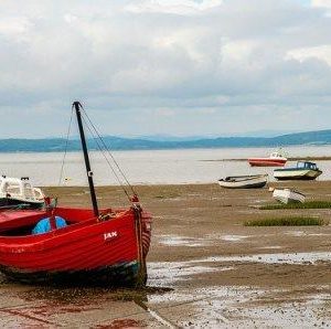 empty red boat on beach