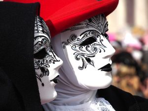 headshot of man and woman wearing facemasks, venice carnival