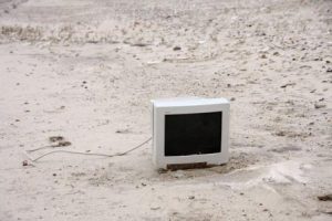 one computer monitor on a sandy beach
